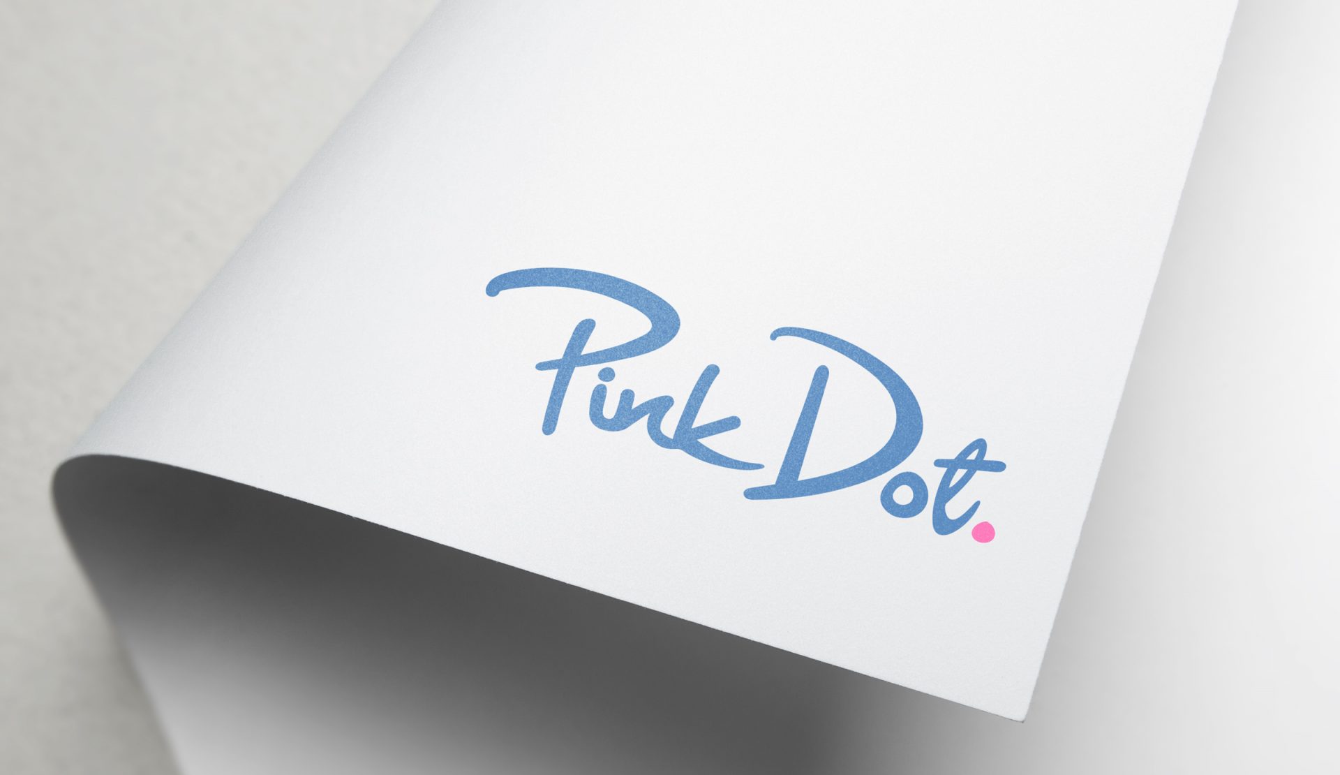 Pink Dot wordmark printed on folded paper